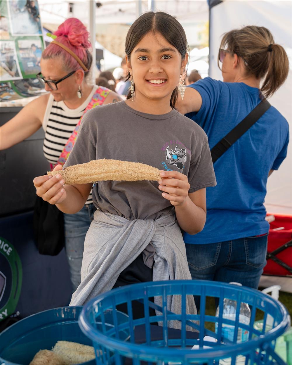 A Rice Elementary School student holds produce from Rice's community garden.